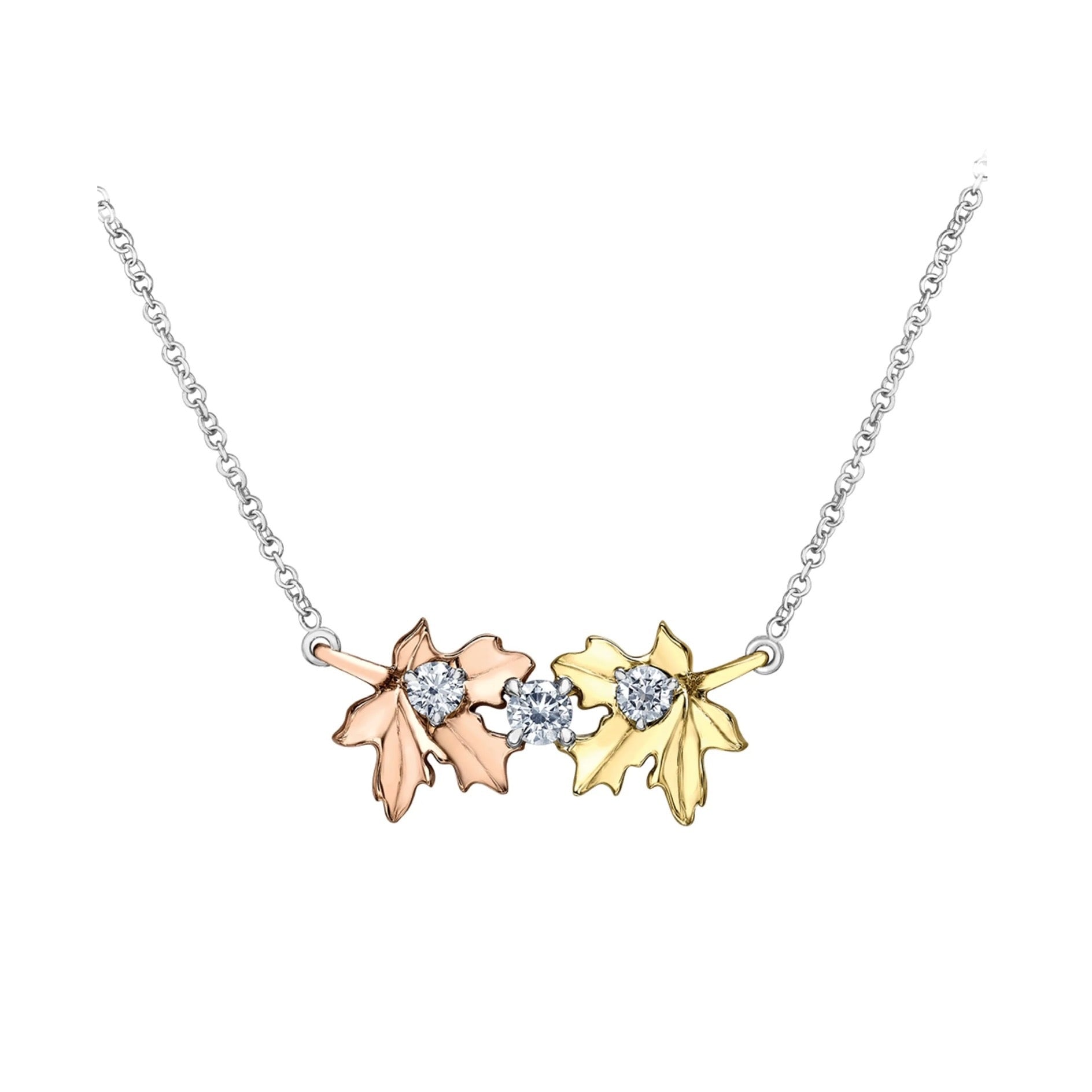 Crafted in 14KT rose and yellow Certified Canadian Gold, this necklace features two maple leaves set with three round brilliant-cut Canadian diamonds.