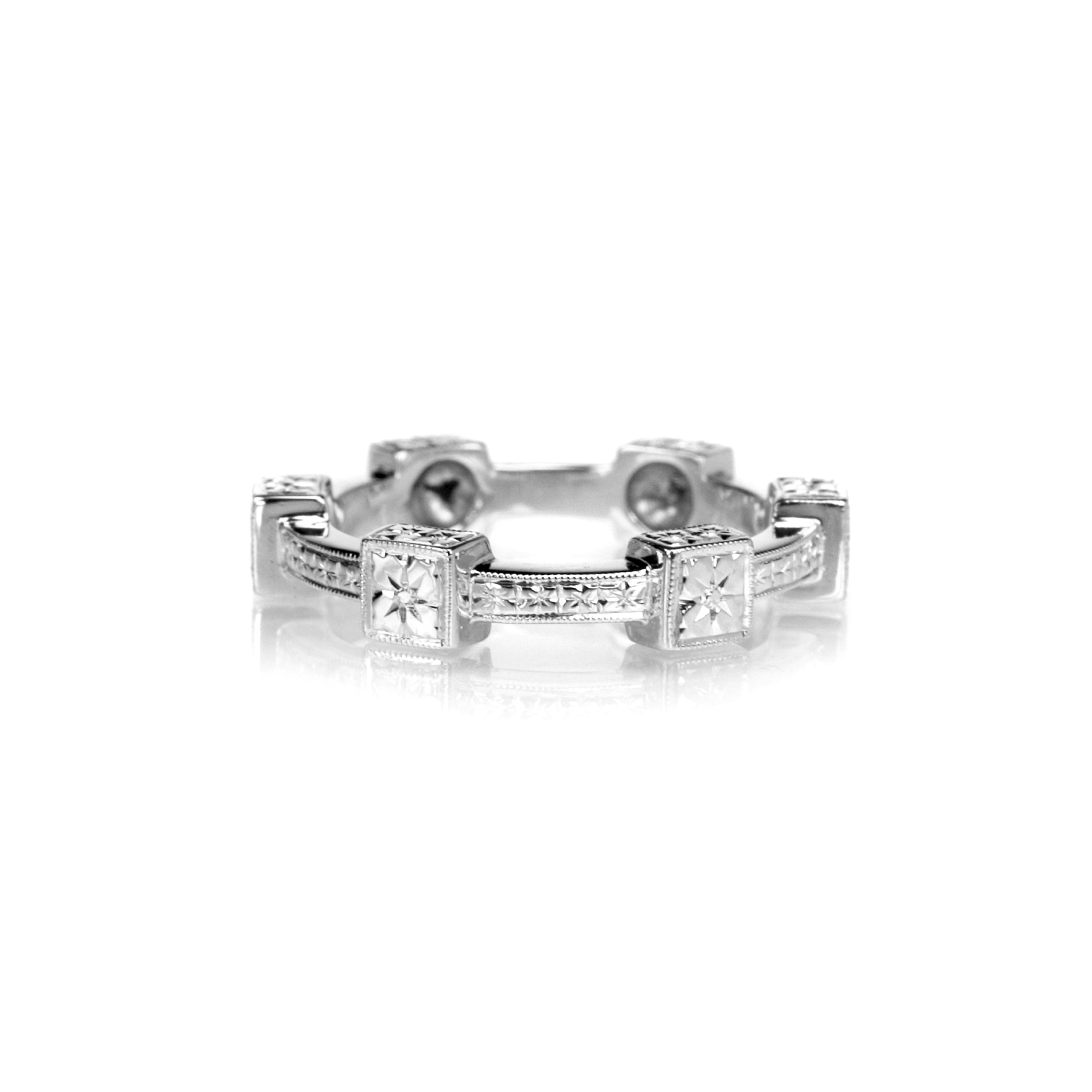 Crafted in 14KT white gold, this ring features orange blossom hand-engravings in square settings and on the band.
