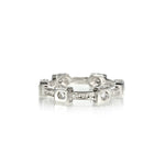 Crafted in 14KT white gold, this ring features six round brilliant-cut diamonds in square bezel settings and flat edges with orange blossom hand-engravings.