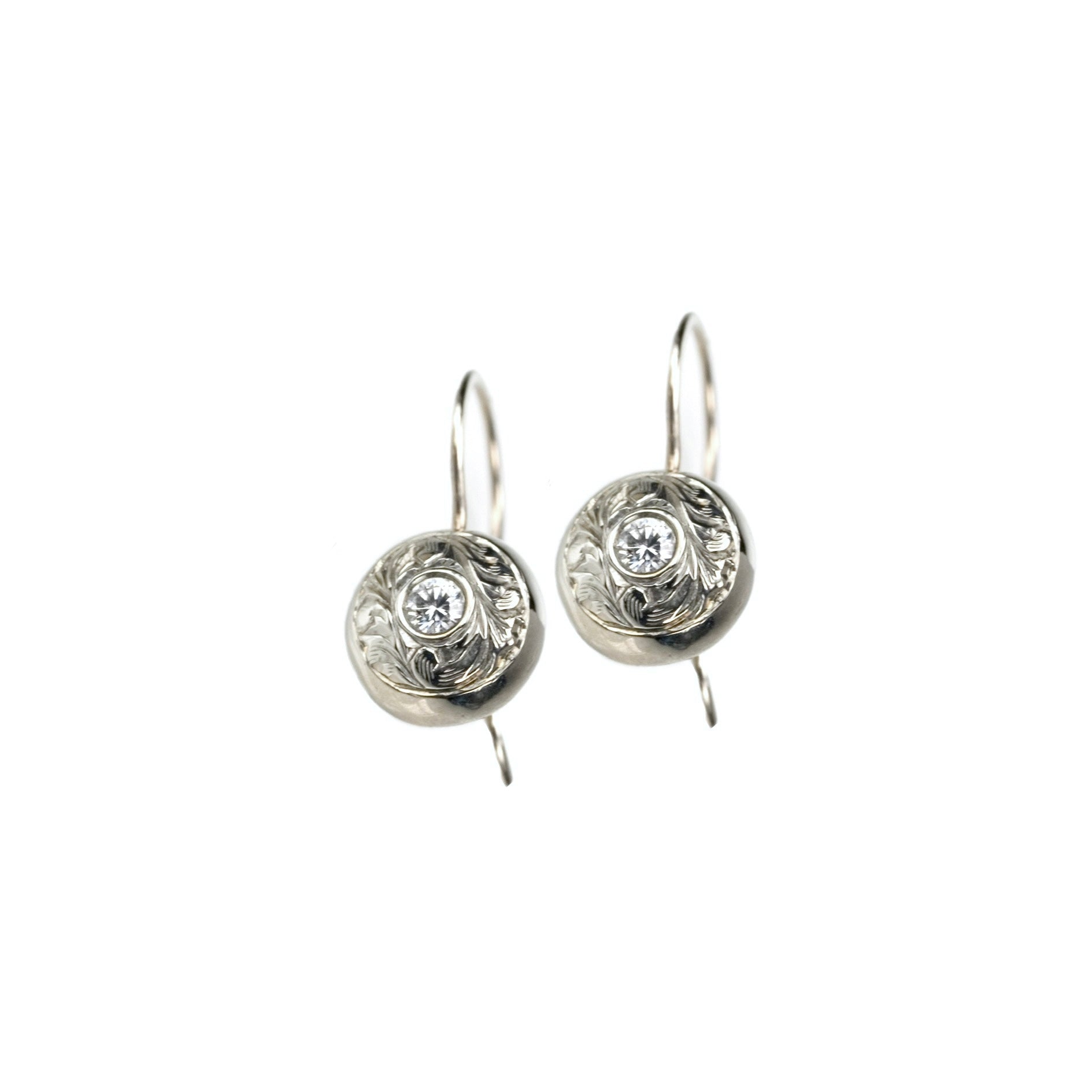 Crafted in 14KT white gold, these drop earrings feature round brilliant-cut diamonds with paisley hand-engraved halos. 