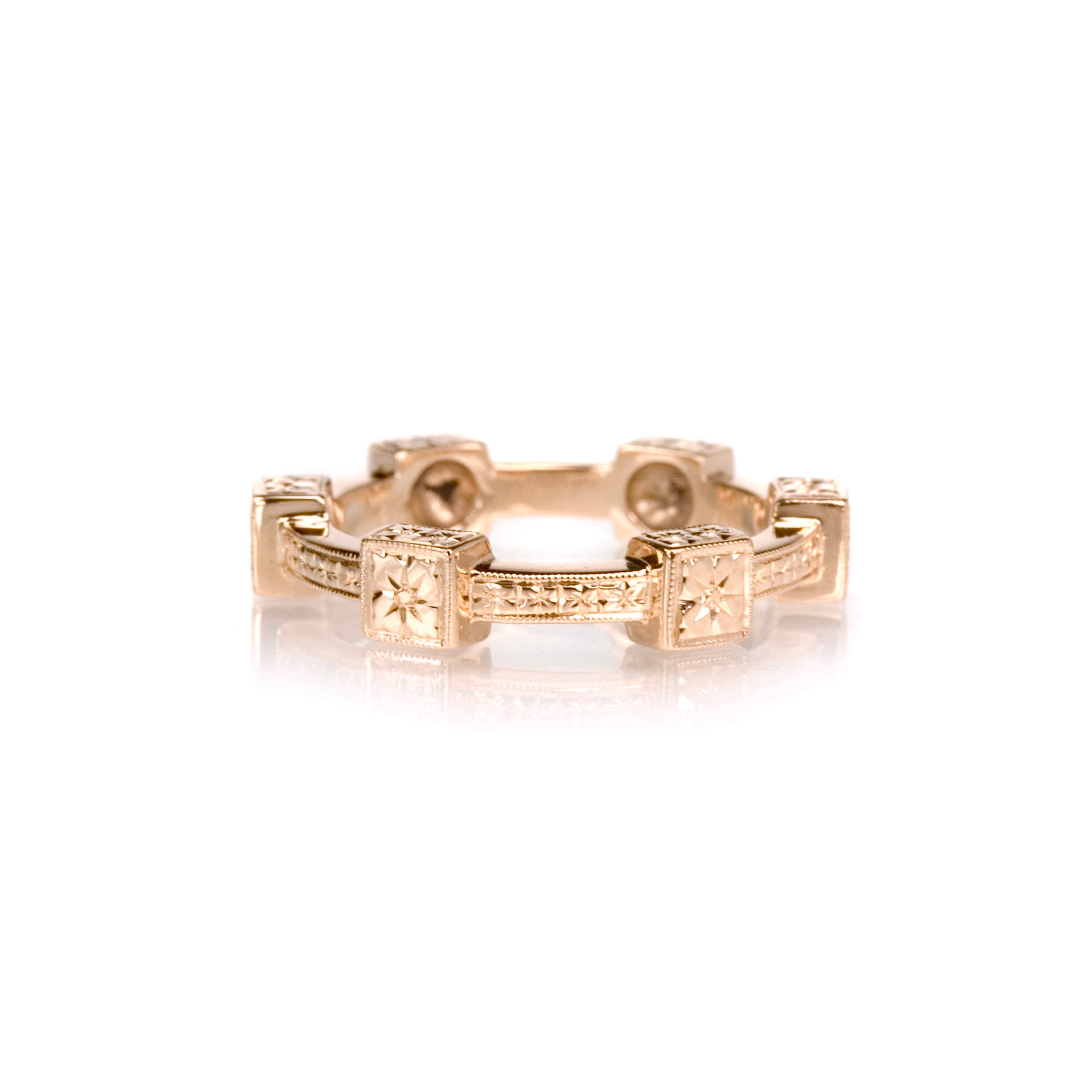 Crafted in 14KT rose gold, this ring features orange blossom hand-engravings in square settings and on the band.