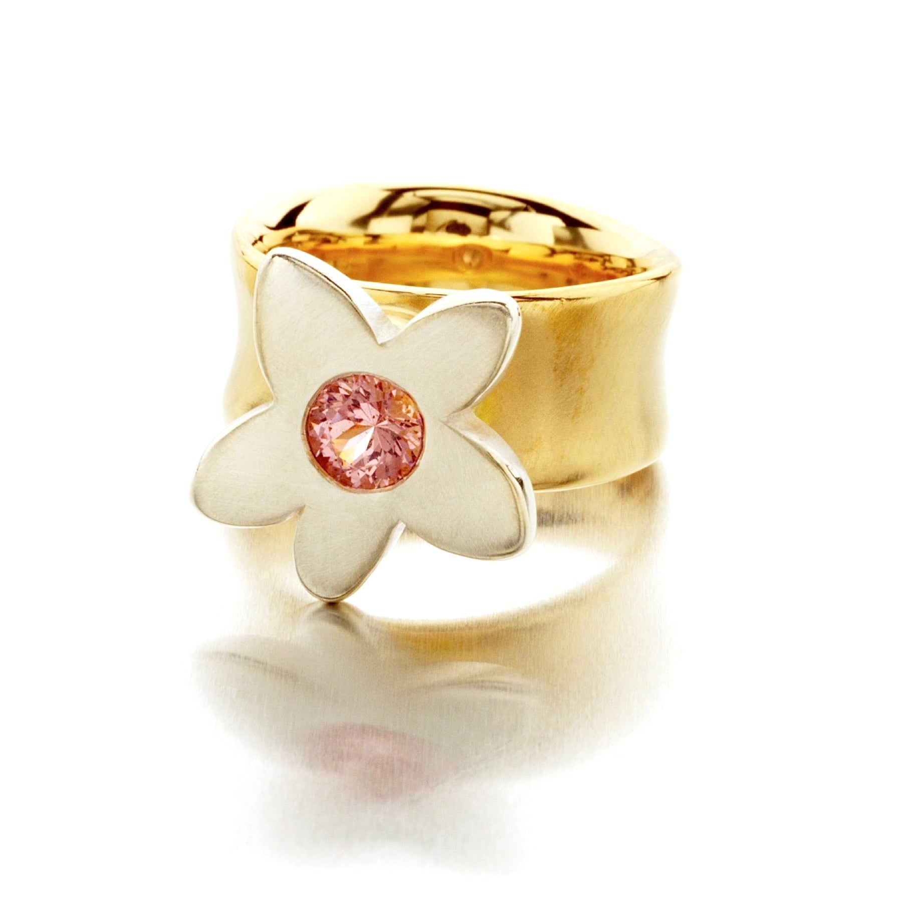 Crafted in 14KT yellow band and white gold, this ring features a large flower with a pink sapphire centre.