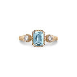 Crafted in 14KT yellow gold, this ring features an aquamarine between two round brilliant-cut diamonds on a vintage-inspired hand engraved band.