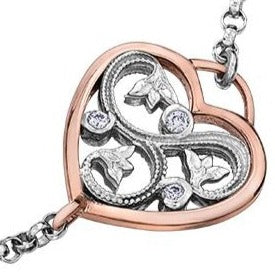 Crafted in 14KT white and rose Certified Canadian Gold, this bracelet features a rose vine design set with round brilliant-cut Canadian diamonds all enclosed in a heart shape.