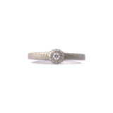 Crafted in 14KT brushed white gold, this ring features a bezel-set round brilliant-cut diamond on a flat band.
