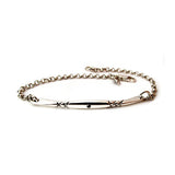 Crafted in 14KT white gold, this bracelet has a bar set with a black diamond and x-designs.