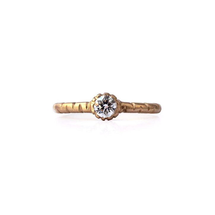 Crafted in 14KT brushed yellow gold, this ring features a bezel-set round brilliant-cut diamond on a semi-quilted band.