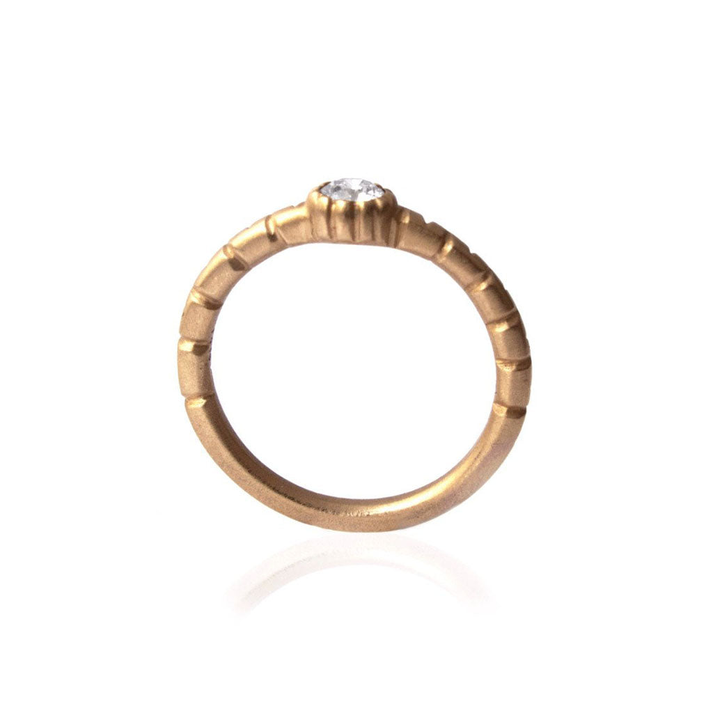 Crafted in 14KT brushed yellow gold, this ring features a bezel-set round brilliant-cut diamond on a semi-quilted band.