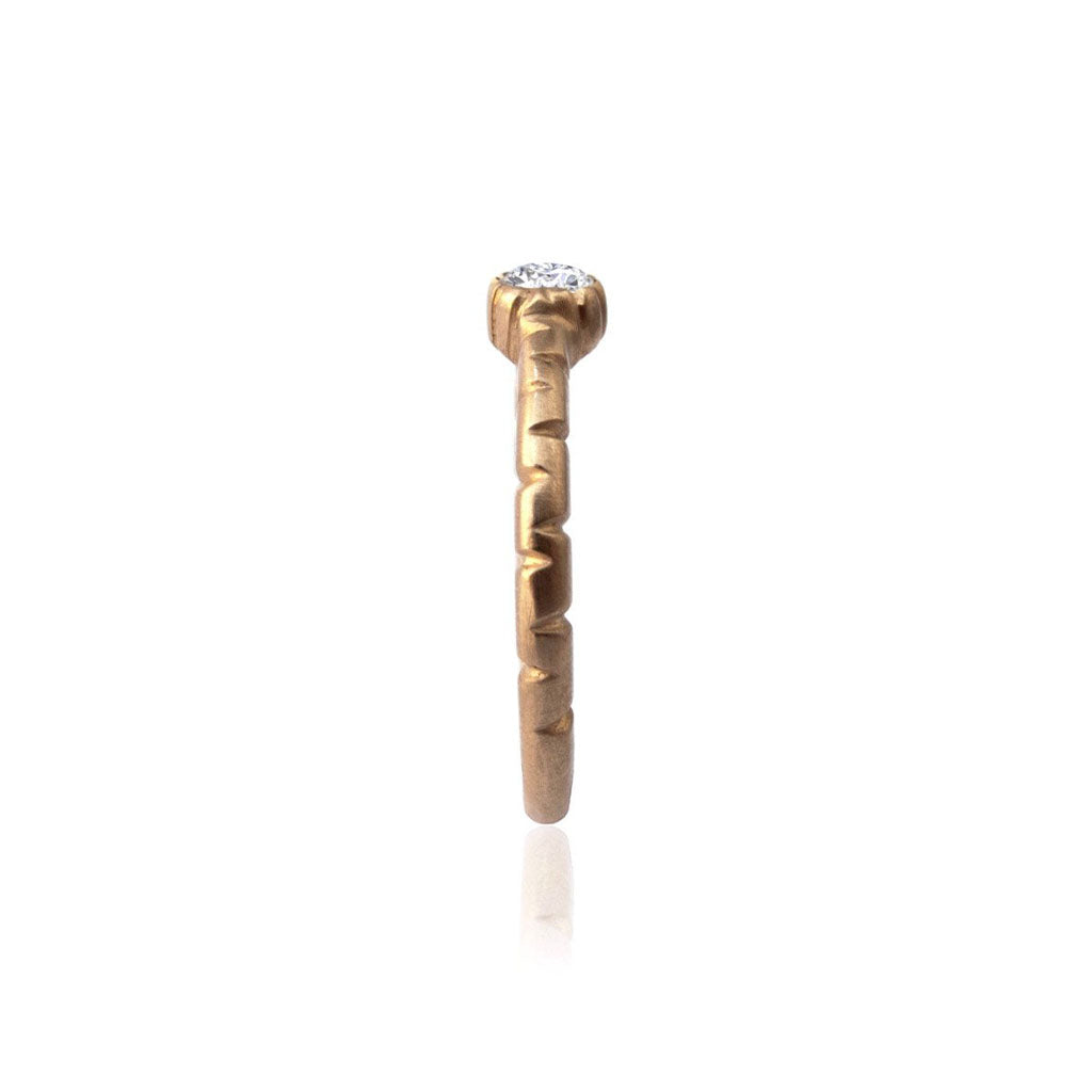 Crafted in 14KT brushed yellow gold, this ring features a bezel-set round brilliant-cut diamond on a semi-quilted band.