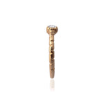 Crafted in 14KT brushed yellow gold, this ring features a bezel-set round brilliant-cut diamond on a semi-quilted band.