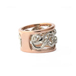 Crafted in 14KT white and rose gold, this ring features a diamond-set vine design with fleur de lys. 