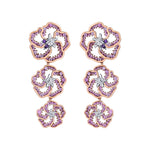 Crafted in 14K white Certified Canadian Gold, these dangling earrings feature three wildflowers set with amethyst, pink sapphires and round brilliant-cut Canadian diamonds.