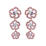 Crafted in 14K white Certified Canadian Gold, these dangling earrings feature three wildflowers set with amethyst, pink sapphires and round brilliant-cut Canadian diamonds.