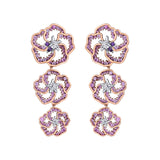 Crafted in 14K white Certified Canadian Gold, these dangling earrings feature three wildflowers set with amethyst, pink sapphires and round brilliant-cut Canadian diamonds.  