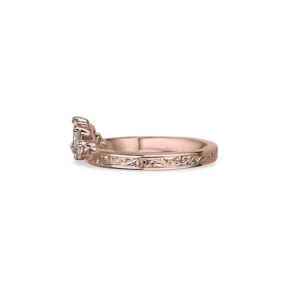 Crafted in 14KT rose gold, this crown inspired ring features 5 tapered baguette diamonds in a row on a vintage-inspired hand engraved band.