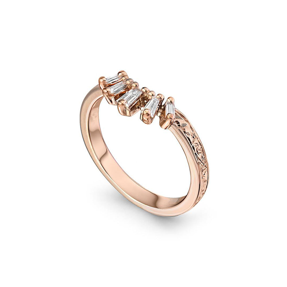 Crafted in 14KT rose gold, this crown inspired ring features 5 tapered baguette diamonds in a row on a vintage-inspired hand engraved band.