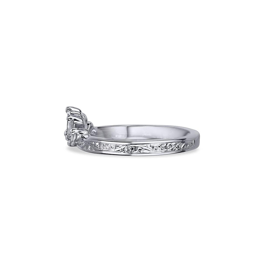 Crafted in 14KT white gold, this crown inspired ring features 5 tapered baguette diamonds in a row on a vintage-inspired hand engraved band.