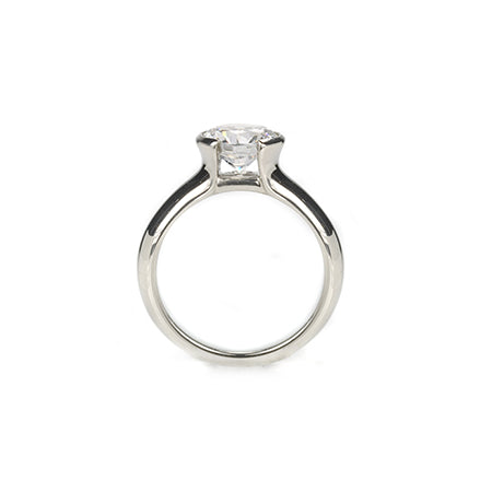 Crafted in 14KT white gold, this ring features a round-cut diamond in a half-bezel setting.