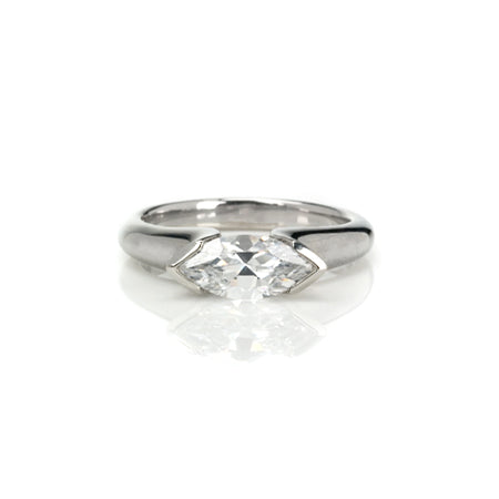 Crafted in 14KT white gold, this ring features a half-bezel set marquise-cut diamond horizontally on the band.
