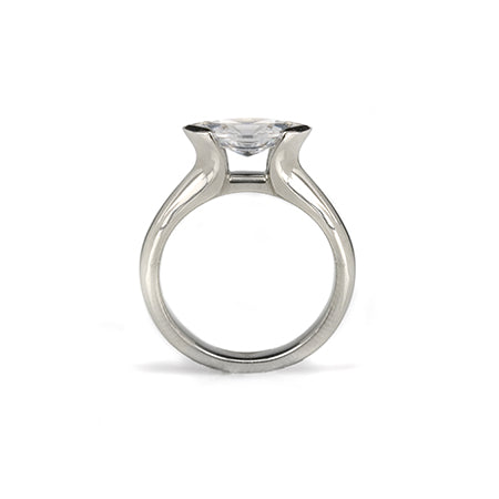 Crafted in 14KT white gold, this ring features a half-bezel set marquise-cut diamond horizontally on the band.