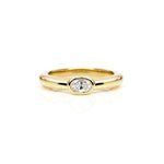 Crafted in 14KT yellow gold, this ring features a bezel set oval-cut diamond.