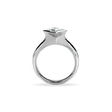 Crafted in 14KT white gold, this ring features a bezel set princess-cut diamond.