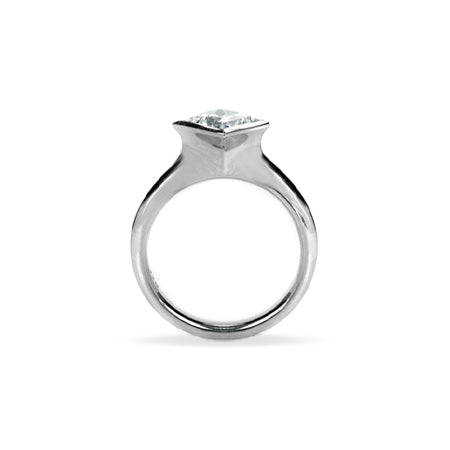 Crafted in 14KT white gold, this ring features a bezel set princess-cut diamond.