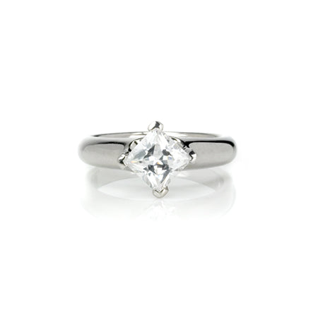 Crafted in 14KT white gold, this ring features a princess-cut diamond in a diagonal prong setting.
