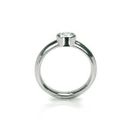 Crafted in 14KT white gold, this ring features a bezel set round brilliant-cut diamond.