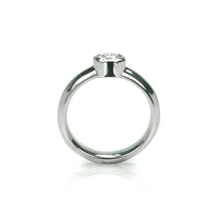 Crafted in 14KT white gold, this ring features a bezel set round brilliant-cut diamond.