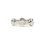 Crafted in 14KT white gold, this ring features six round brilliant-cut diamonds spaced apart in bezel settings.