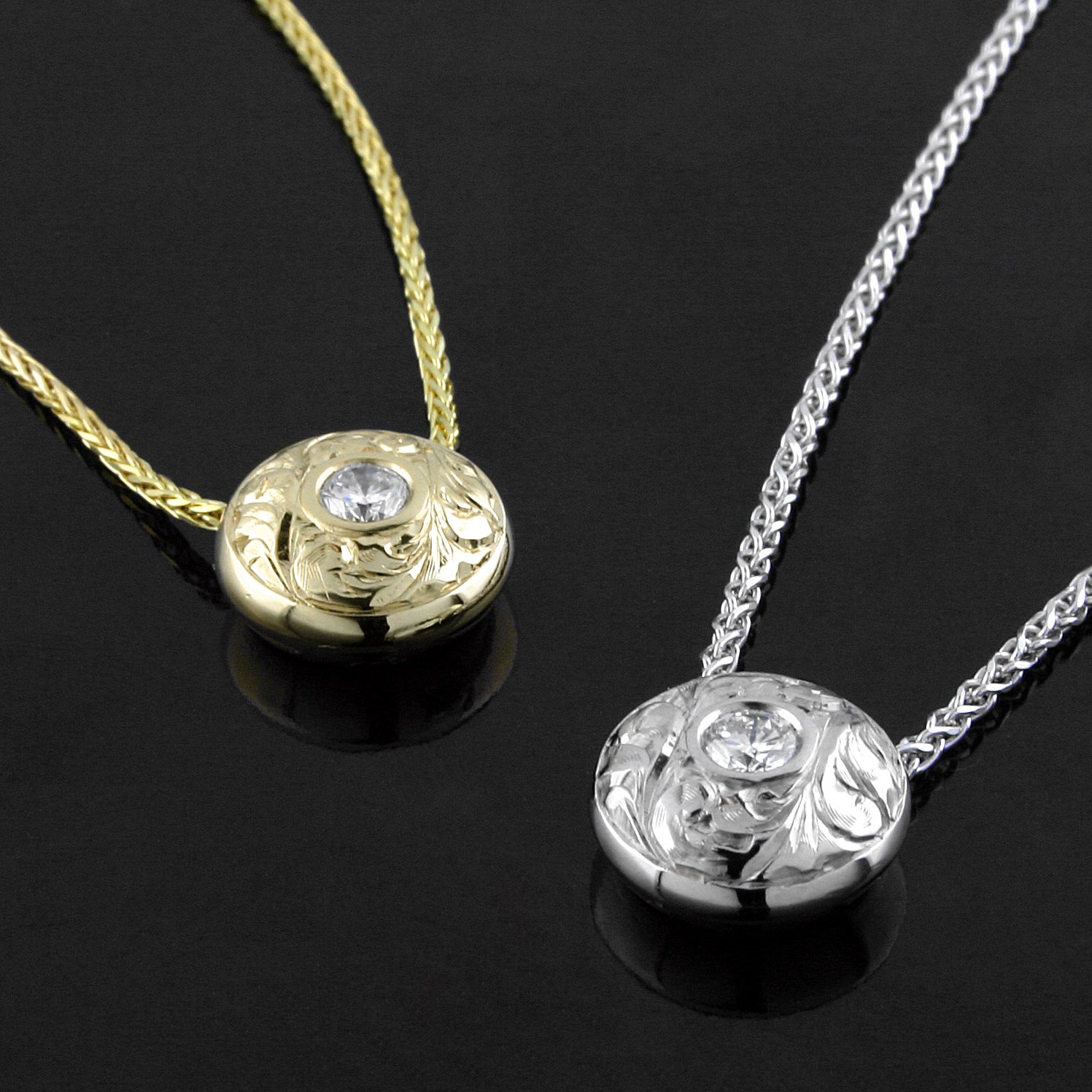 A 14KT white gold and a 14KT yellow gold ‘Opulence Paisley Hand-engraved Diamond Pendant’ are shown side by side.