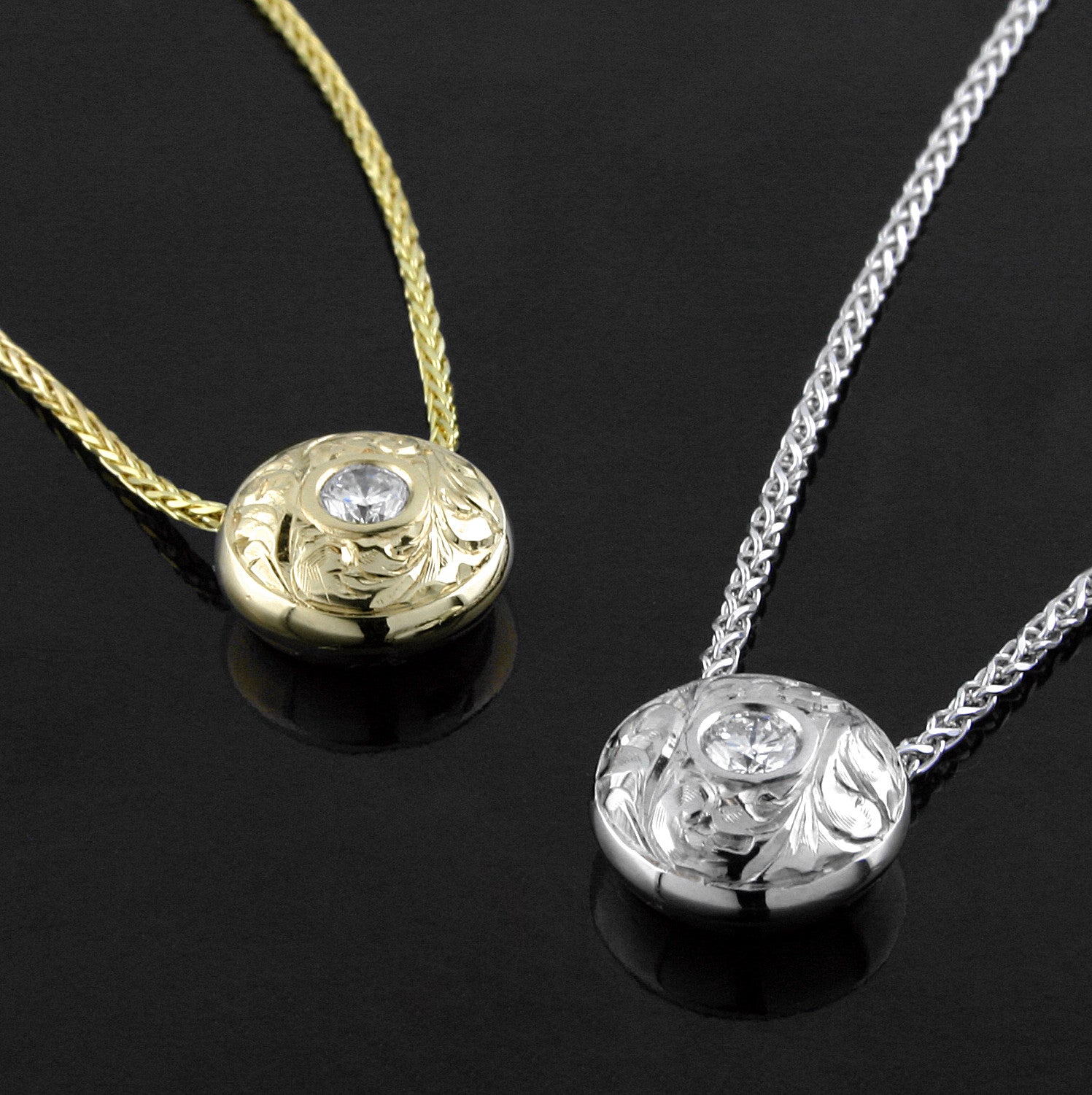 A 14KT white gold and a 14KT yellow gold ‘Opulence Paisley Hand-engraved Diamond Pendant’ are shown side by side.