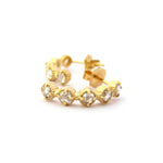 Crafted in 14KT yellow gold, these half-hoop earrings feature five rose-cut diamonds each in cupcake settings.