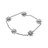 Crafted in 14KT Certified Canadian Gold, this bracelet features five water lily flowers set with round brilliant-cut centre diamonds.