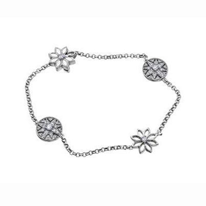 Crafted in 14KT Certified Canadian Gold, this bracelet features four water lily flowers, two of them filigree, set with round brilliant-cut diamonds. 