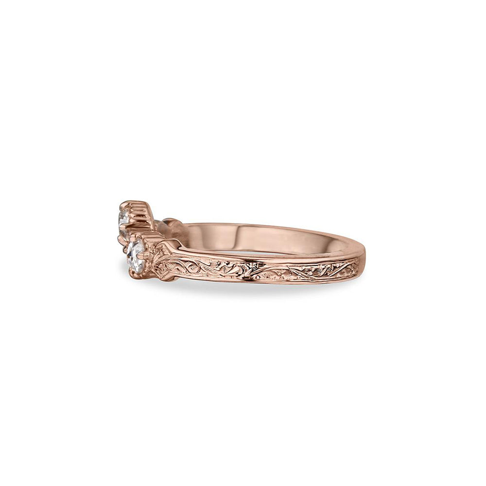 Crafted in 14KT rose gold, this ring has a curve featuring 3 rose-cut diamonds in a row on a vintage-inspired hand engraved band.