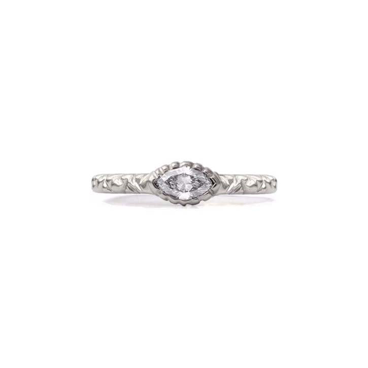 Crafted in 14KT brushed white gold, this ring features a bezel-set marquise-cut diamond on a quilted band.