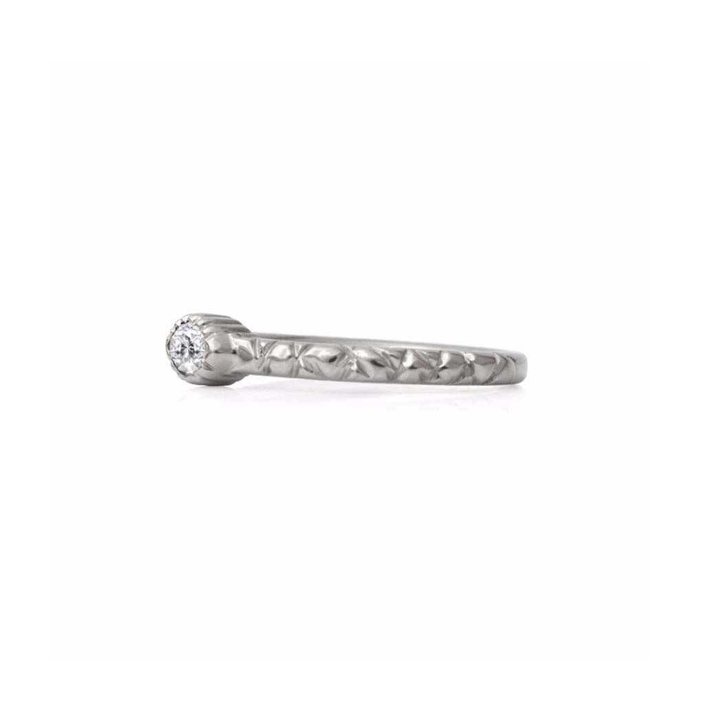 Crafted in 14KT brushed white gold, this ring features a bezel-set marquise-cut diamond on a quilted band.