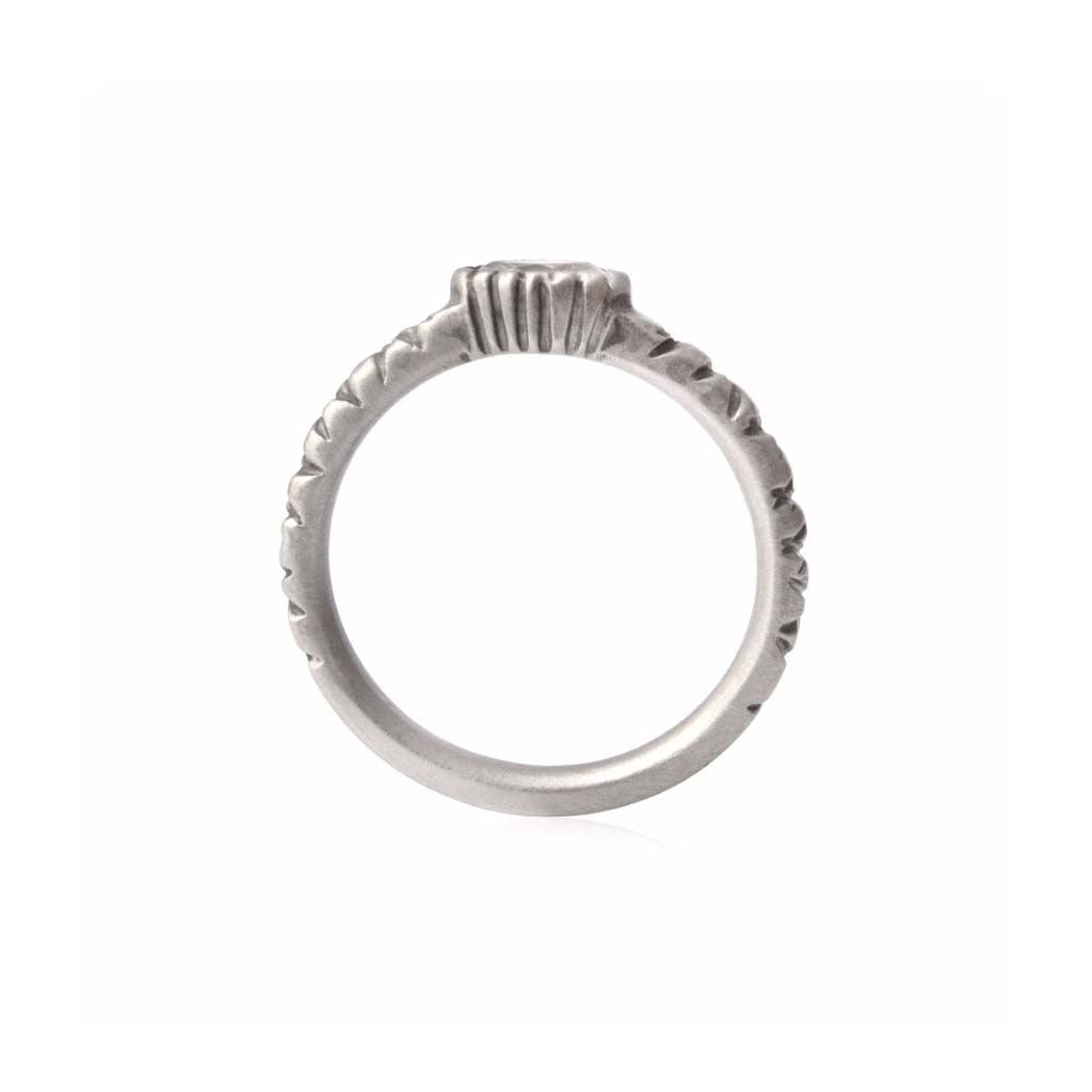 Crafted in 14KT brushed white gold, this ring features a bezel-set marquise-cut diamond on a quilted band.
