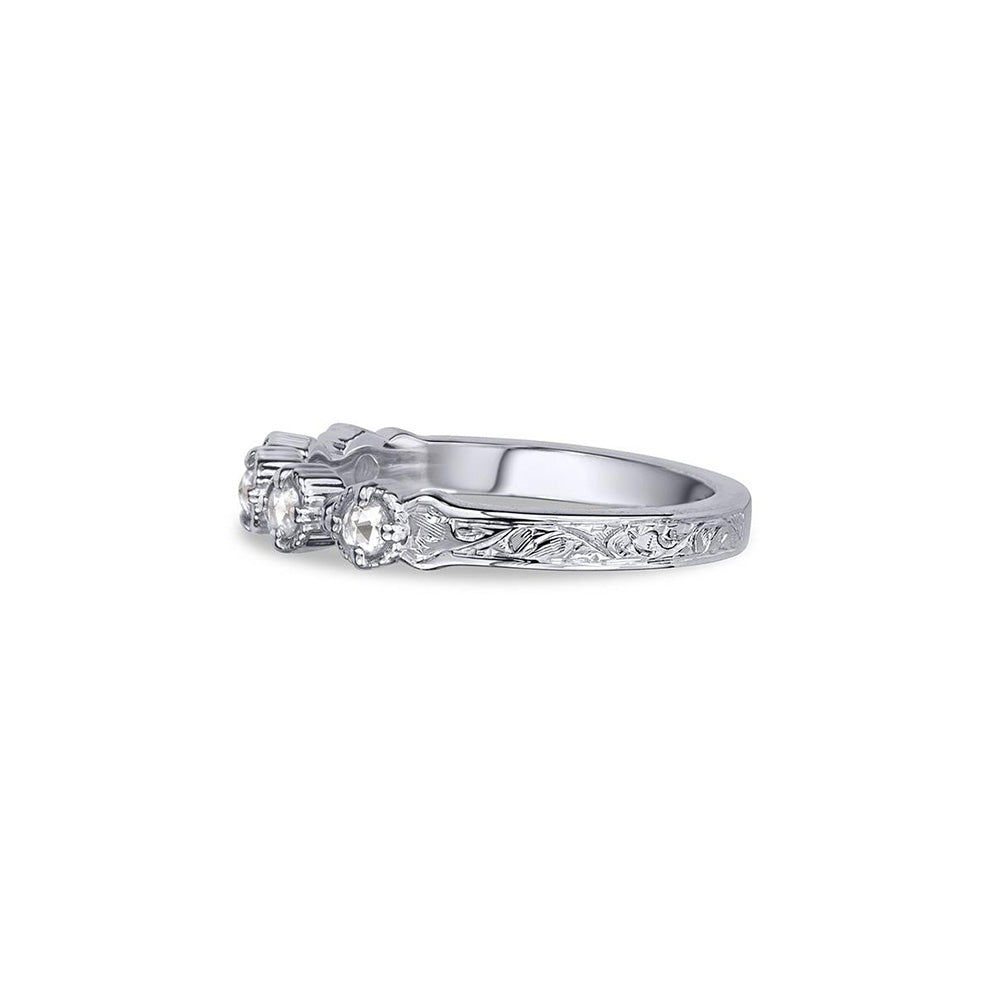 Crafted in 14KT white gold, this ring features five rose-cut diamonds in cupcake settings on a vintage-inspired hand engraved band. 