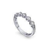 Crafted in 14KT white gold, this ring features five rose-cut diamonds in cupcake settings on a vintage-inspired hand engraved band.