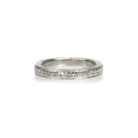 Crafted in 14KT white gold, this band is hand-engraved with an orange blossom design.
