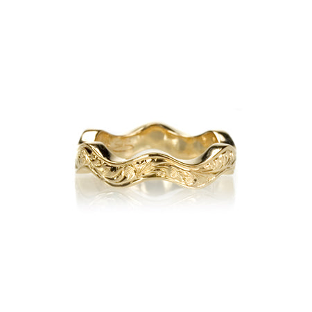 Crafted in 14KT yellow gold, this ring has a ruffled band with orange blossom hand-engravings.