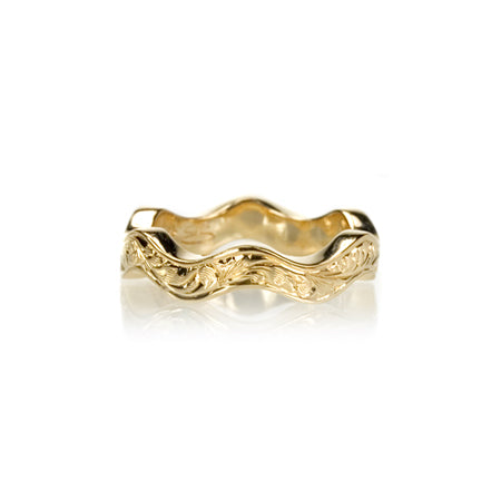 Crafted in 14KT yellow gold, this ring has a ruffled band with orange blossom hand-engravings. 