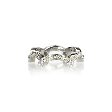 Crafted in 14KT white gold, this ring has a scallop design with orange blossom hand-engravings and six round brilliant-cut diamonds.