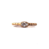 Crafted in 14KT brushed yellow gold, this ring features a bezel-set oval-cut diamond on a quilted band. 