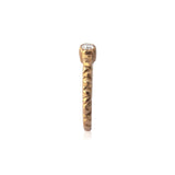 Crafted in 14KT brushed yellow gold, this ring features a bezel-set oval-cut diamond on a quilted band.
