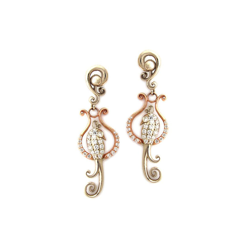 Crafted in 14KT rose and yellow gold, these earrings features birds atop delicate curled perches, both set with round brilliant-cut diamonds.