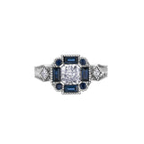 Crafted in 18KT Canadian Certified Gold, this ring features a radiant-cut Canadian diamond framed by round and baguette-cut blue sapphires on a frost-inspired hand engraved band. 